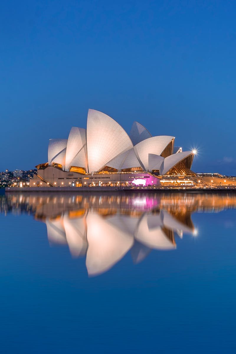 Beautiful view of the Sydney Opera House and its reflection at dusk, highlighting iconic architecture.