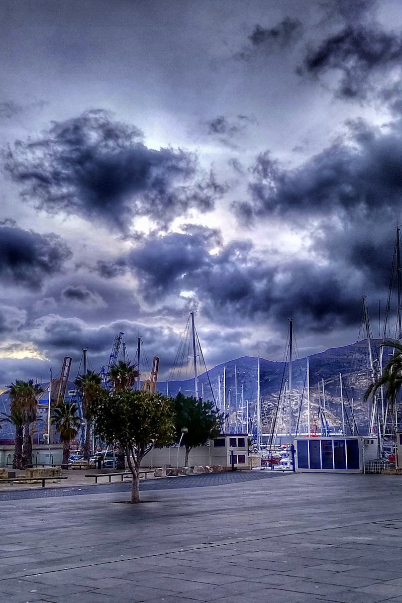 Stormy skies loom over the peaceful harbor in Cartagena, Spain.