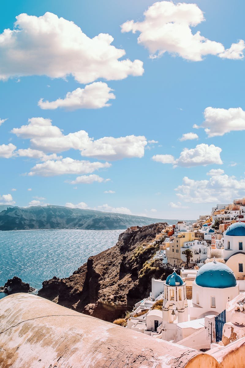 Captivating view of Santorini's famous blue-domed buildings under a vibrant sky.