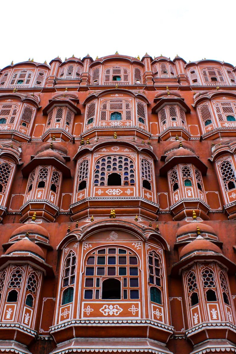 Low angle view of the iconic Hawa Mahal showcasing its elaborate facade in Jaipur, India.