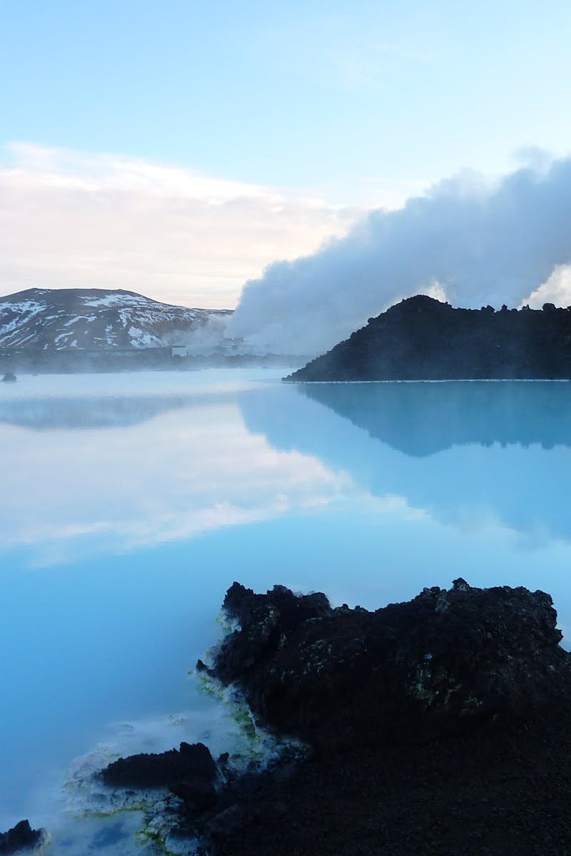Captivating view of the Blue Lagoon in Iceland with steaming geothermal waters and distant mountains.