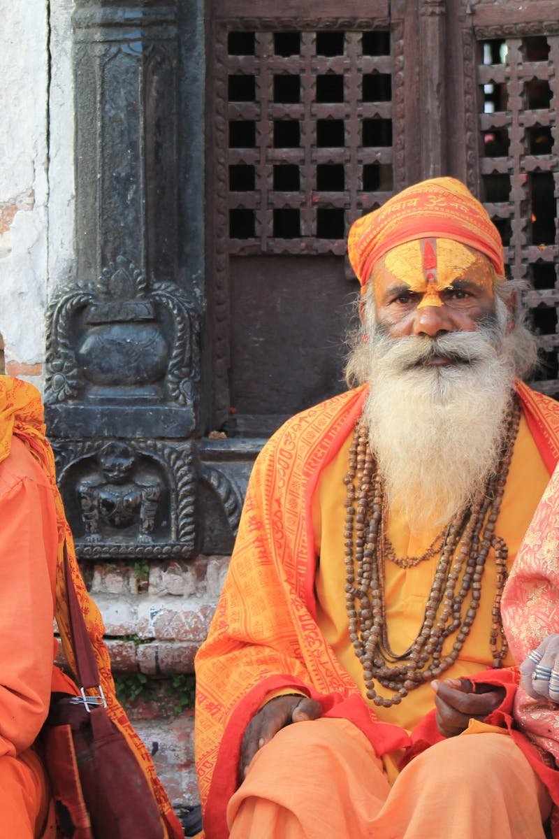 Three sadhus in traditional attire at Pashupatinath Temple, Nepal, exemplifying vibrant cultural heritage.