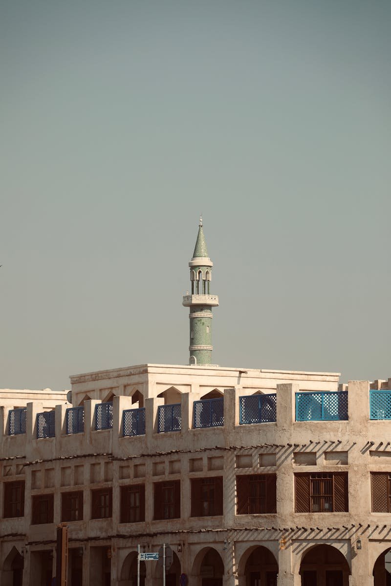 Traditional Qatari architecture with a prominent minaret in Doha, Qatar.