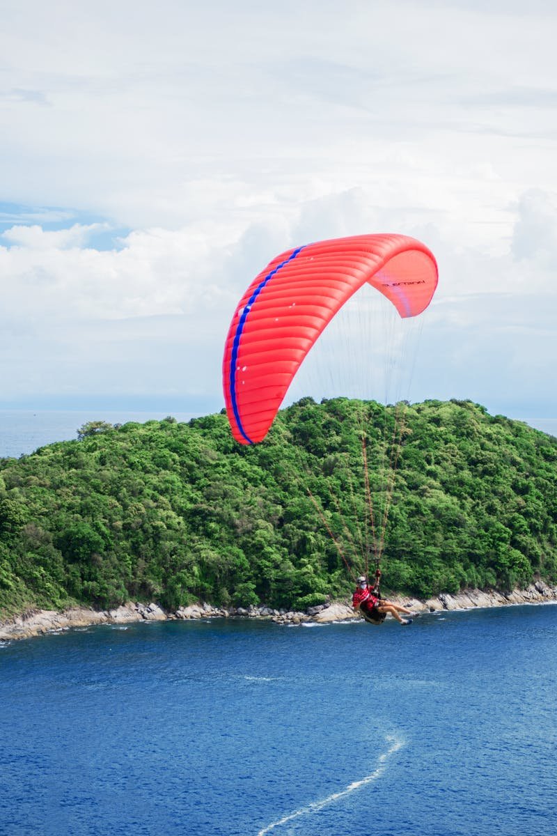 Experience an exhilarating paragliding adventure over lush Phuket island and clear blue waters.