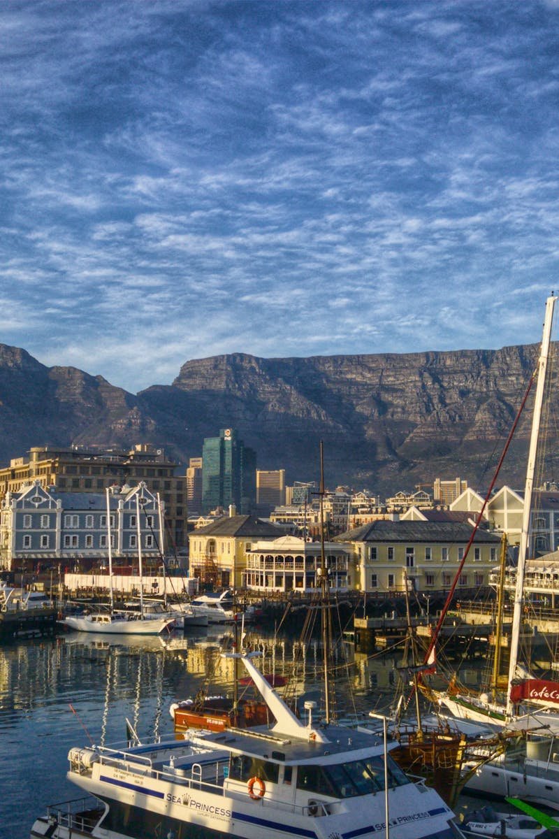 Stunning view of Cape Town harbor with boats and iconic Table Mountain backdrop.
