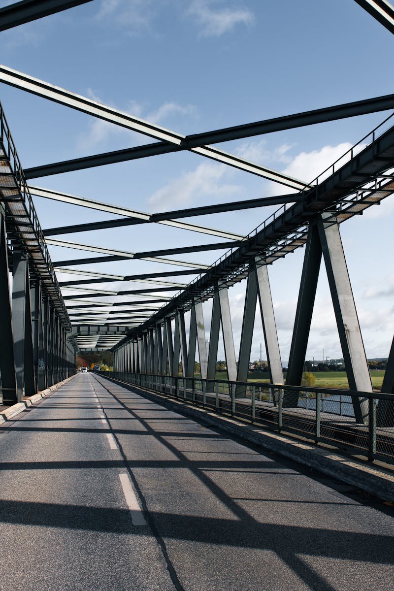 A steel bridge spanning a river in Lauenburg, Germany under a clear blue sky.