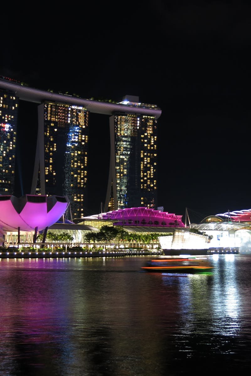 Stunning night view of Marina Bay Sands, Singapore, reflecting on water.