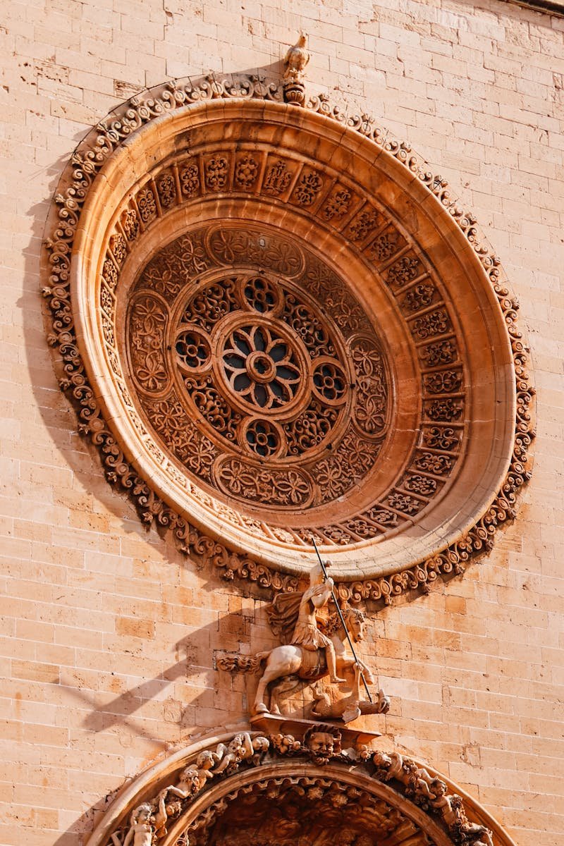 Close-up of the detailed rose window on a historic cathedral facade in Palma, Mallorca.