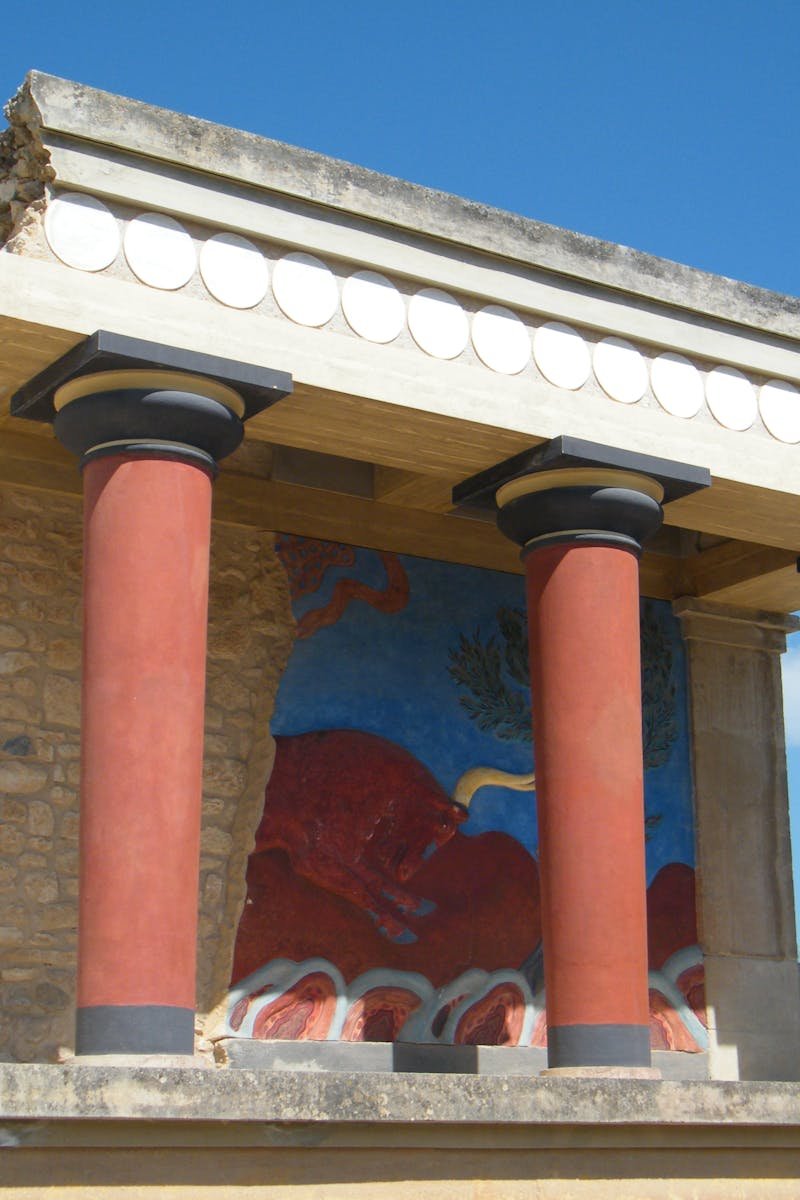 Explore the vibrant colors of ancient Knossos Palace with iconic Minoan columns and frescoes.