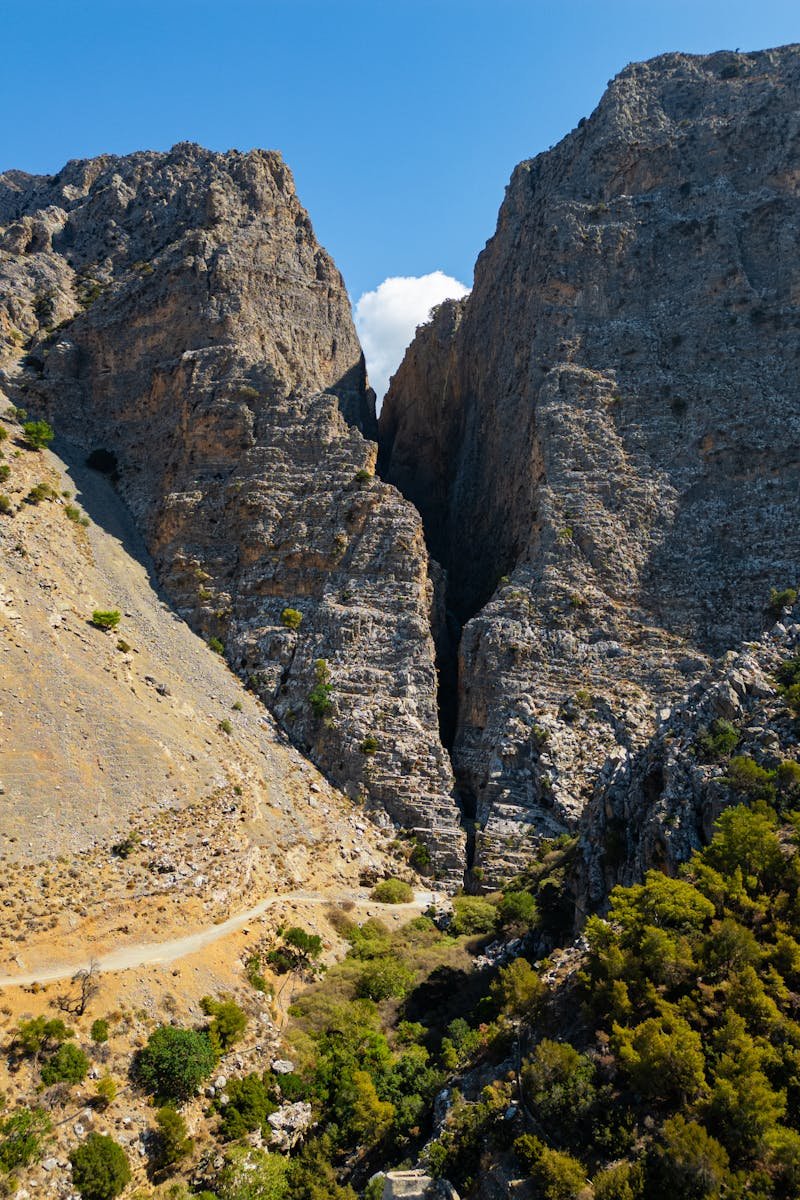 Stunning view of a rocky mountain gorge under a bright blue sky on a sunny day.