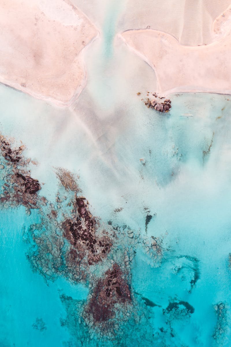 Stunning aerial view of Elafonissi Beach's turquoise waters and sandy shores in Crete, Greece.