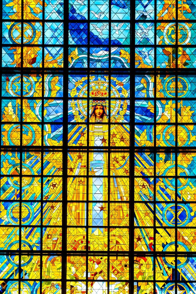 Vibrant stained glass in Basilica of Our Lady of Peace in Yamoussoukro, showcasing religious artistry.