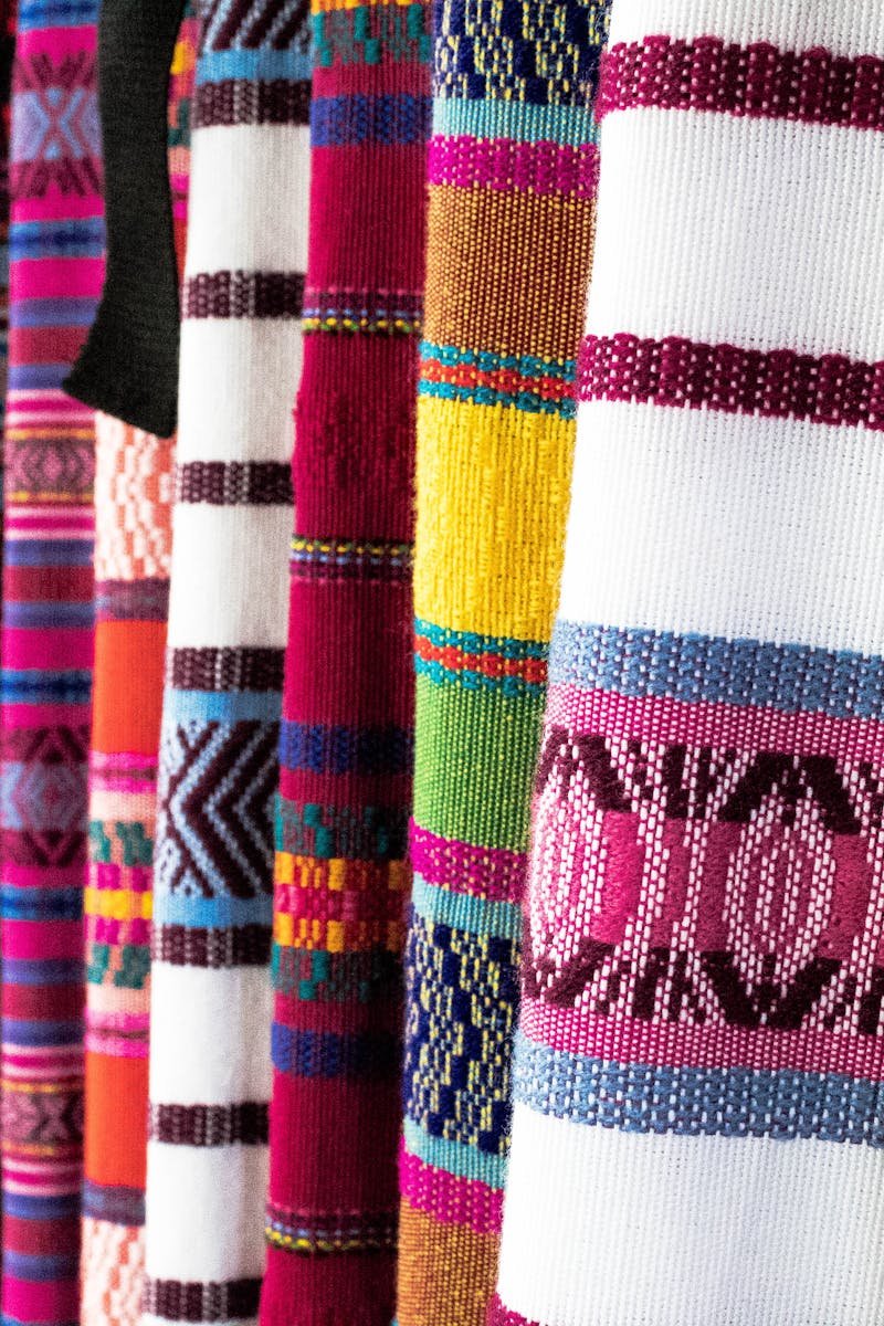 Vibrant woven fabrics showcasing traditional patterns in Antigua Guatemala market.