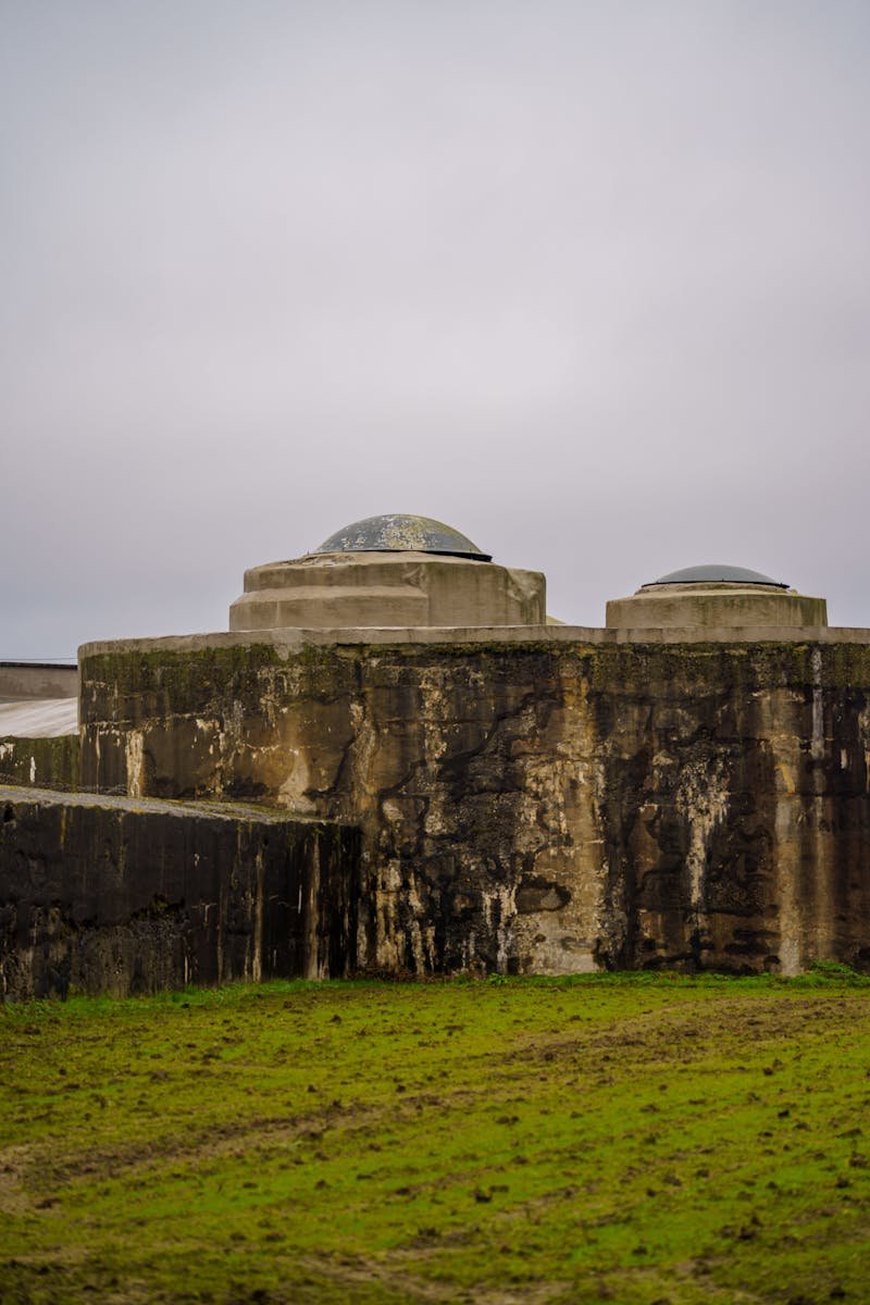 Explore a rugged concrete structure set in the lush countryside of Willebroek, Belgium.
