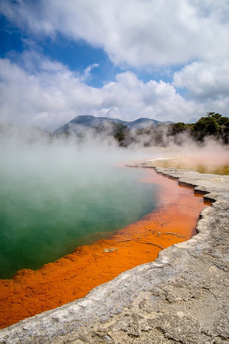 Stunning geothermal Champagne Pool with vivid colors and steam at Wai-O-Tapu, New Zealand.