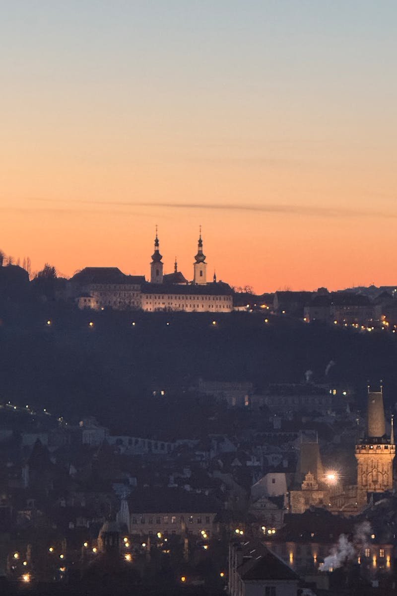 Beautiful sunset view of Prague's skyline with historic architecture and vibrant colors.