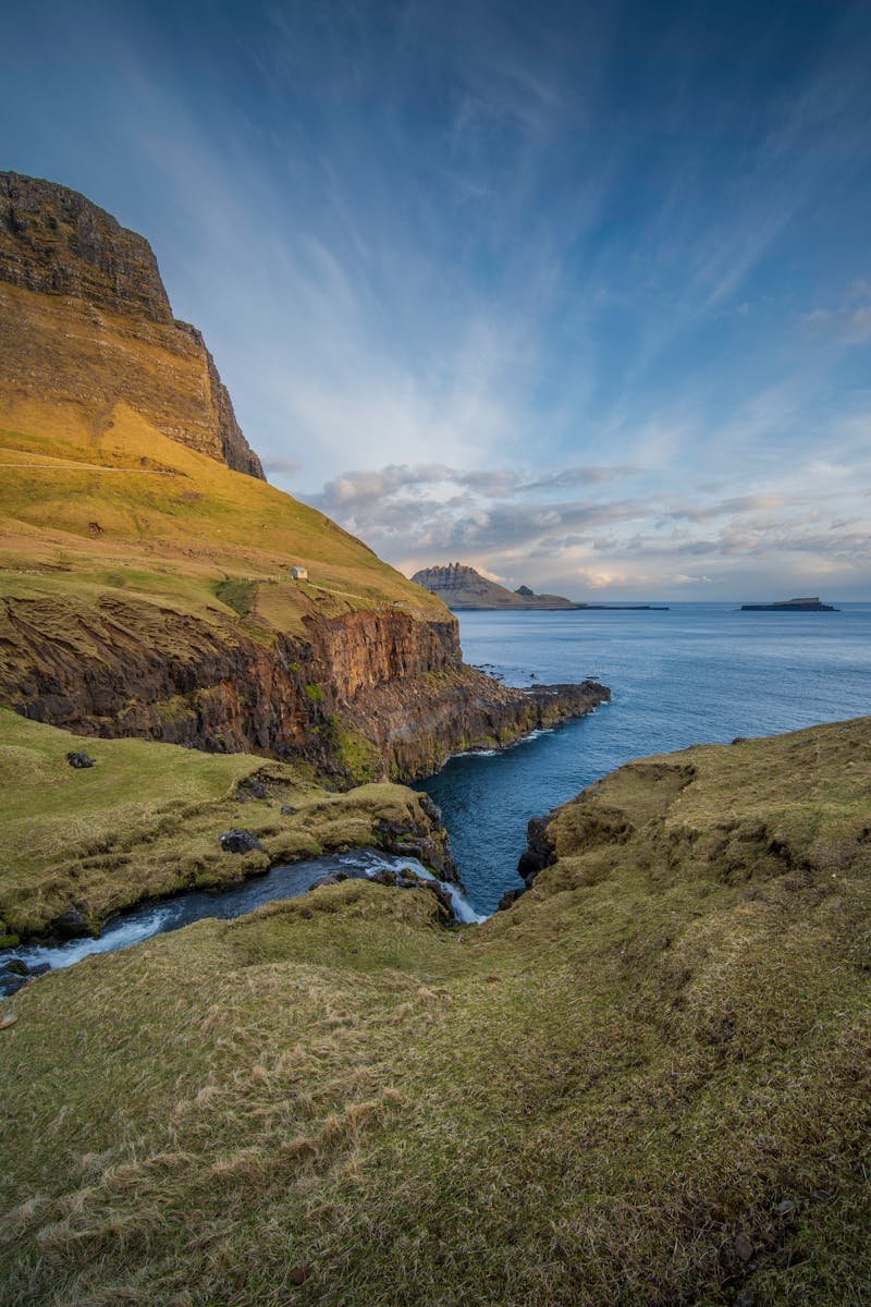 Breathtaking view of the Atlantic Ocean and mossy cliffs in the Faroe Islands.